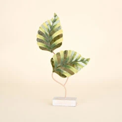 Two Green Leaves On Natural Wood Stand With Mosaic